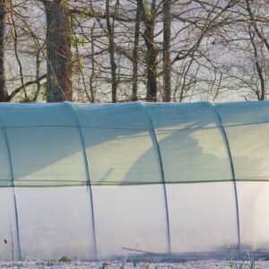 A greenhouse covered with 40% shade cloth to help plants grow faster and stay healthier