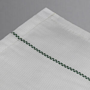 Close up shows woven, geotextile fabric of white ground cover, which helps reduce heat on plants
