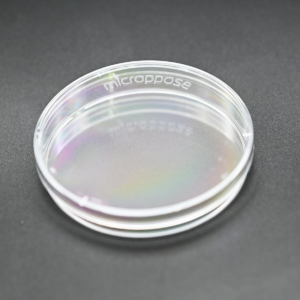A box of clear poyfilm next to a roll of polyfilm with a petri dish covered in polyfilm in front.