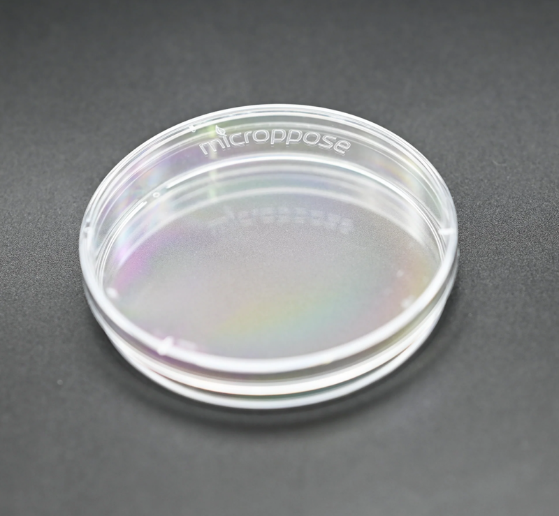 A box of clear poyfilm next to a roll of polyfilm with a petri dish covered in polyfilm in front.