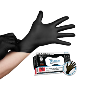 A person putting on black nitrile gloves . Small image of box of gloves in background.