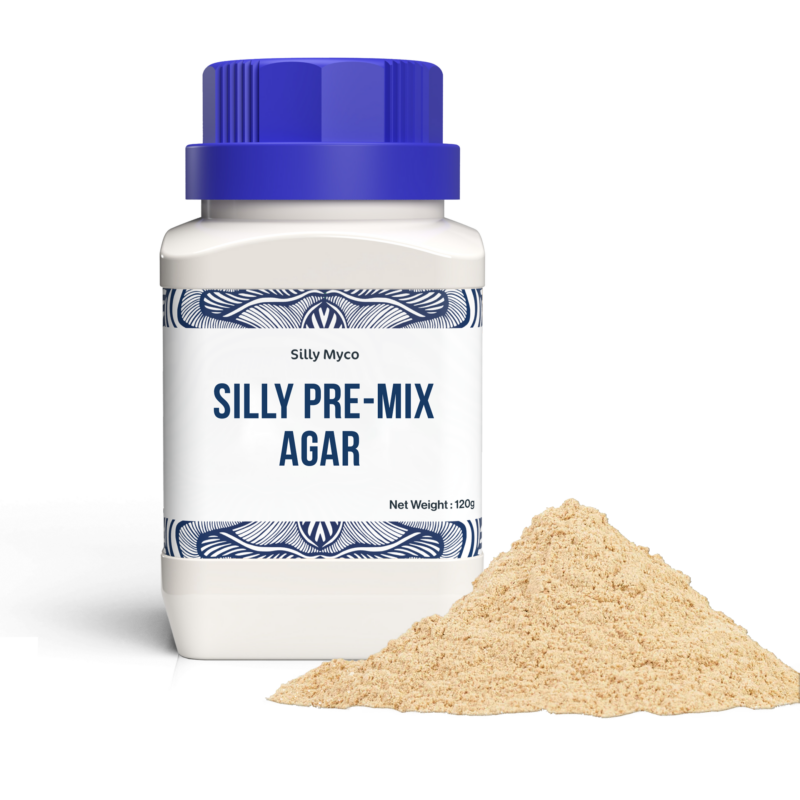A white bottle of Silly Myco Silly Pre-Mix Agar with a blue lid beside a pile of the beige Pre-Mix Agar powder