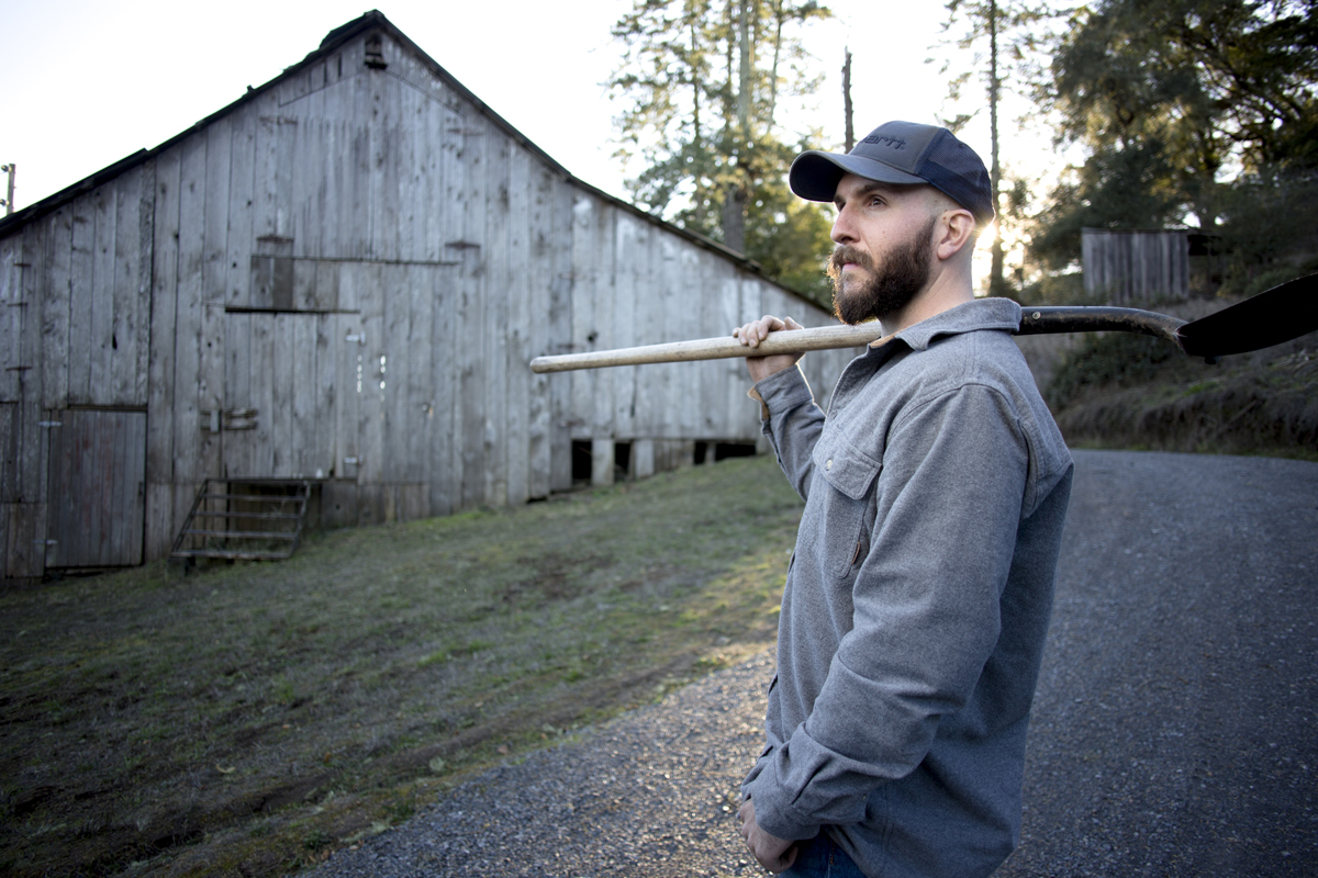 Cultivator overlooking a barn and yard.